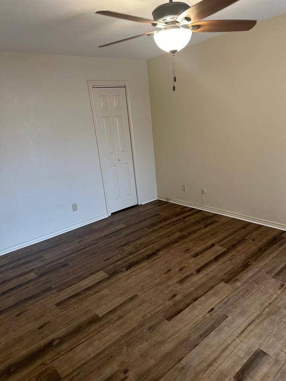 6050 Birchbrook Drive, #242, Dallas, TX 75206 Wood-finish flooring throughout, bright white walls, and a ceiling fan with integrated lighting