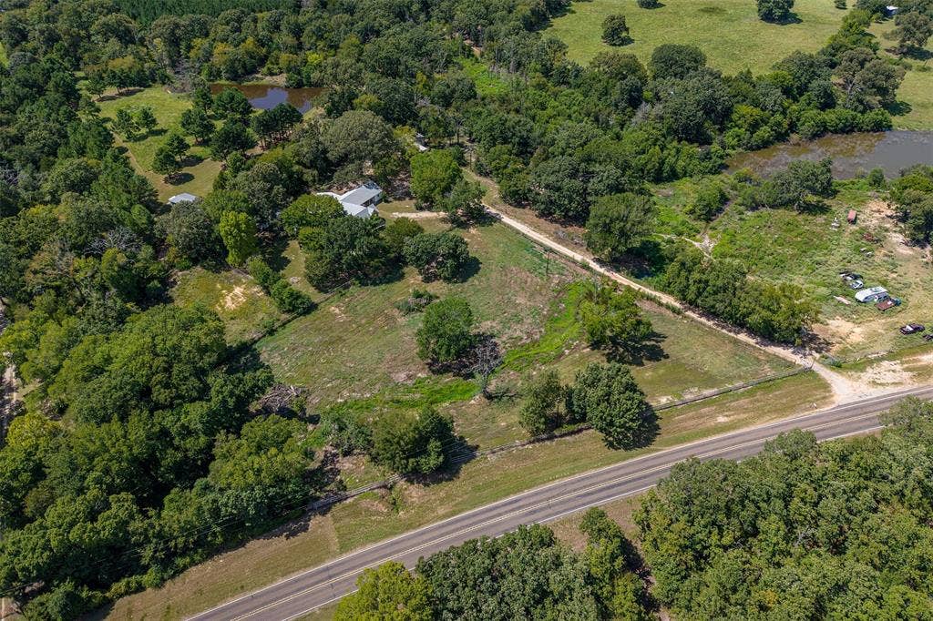 5250 Fm 2494, Athens, TX 75751 Expansive property featuring a paved road frontage, natural ponds, mature trees, and open land sections