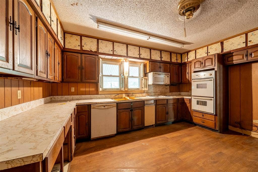 5250 Fm 2494, Athens, TX 75751 Kitchen featuring wood-finish cabinetry, built-in double ovens, and a window above the sink