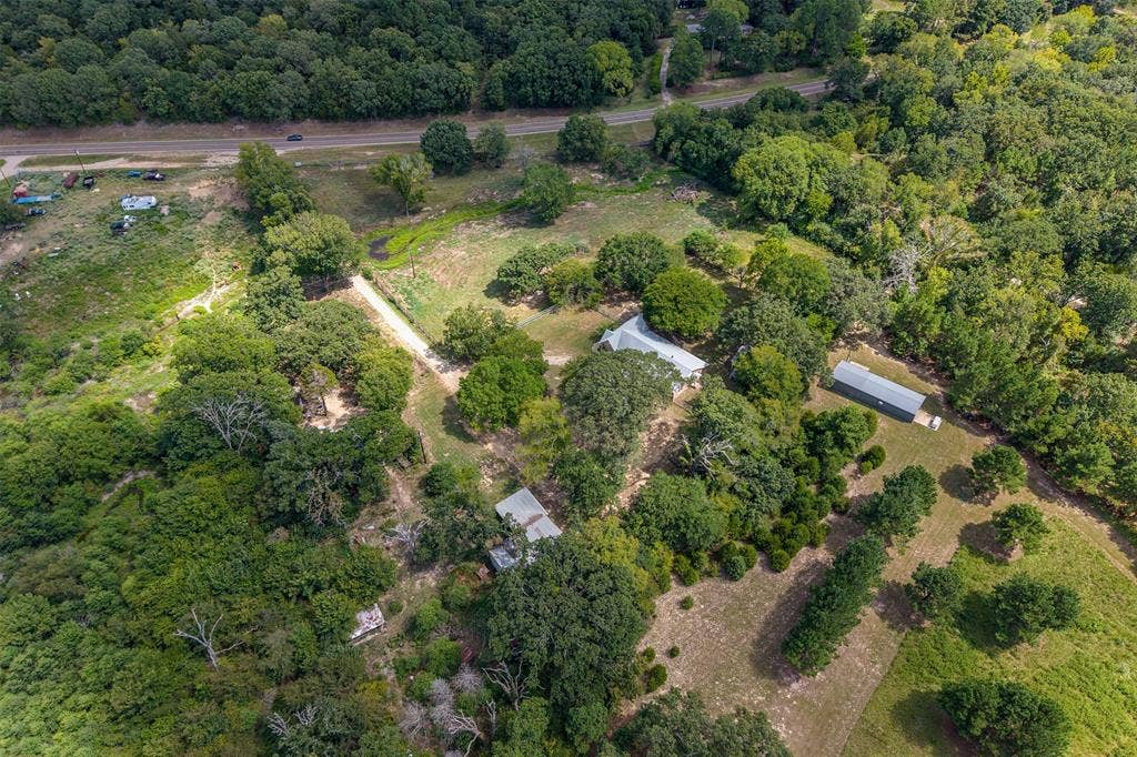 5250 Fm 2494, Athens, TX 75751 Extensive acreage with multiple structures, mature trees, and a visible roadway