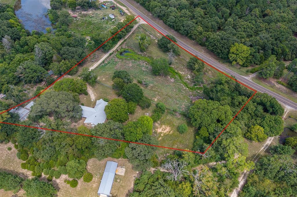 5250 Fm 2494, Athens, TX 75751 Expansive acreage featuring a main residence, a secondary structure, a pond, and dense mature trees