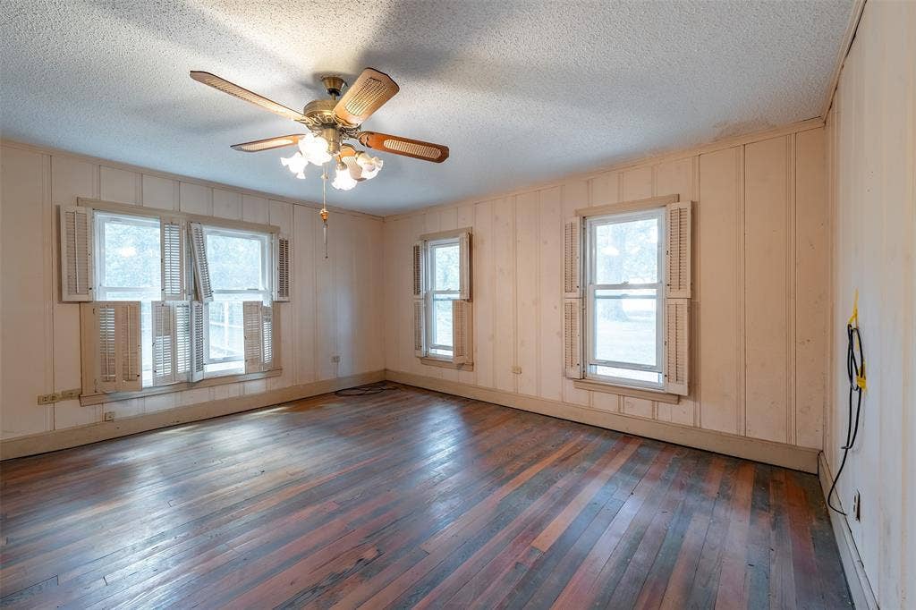 5250 Fm 2494, Athens, TX 75751 Hardwood flooring, wall paneling, ceiling fan with integrated lighting, multiple windows, window shutters