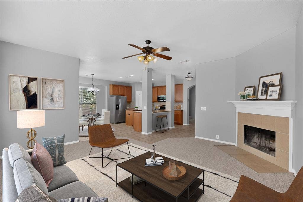 Carpeted living area with a ceiling fan
