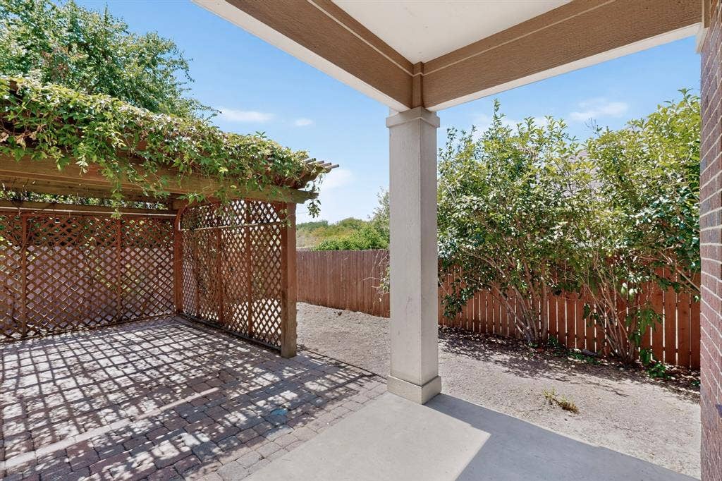 Covered patio with a concrete surface, supported by a substantial column