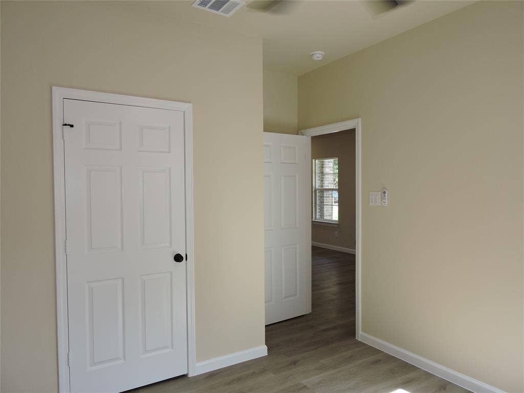 106 Navajo Drive, Mabank, TX 75156 Neutral paint tones with contrasting white trim, modern plank flooring, and paneled interior doors