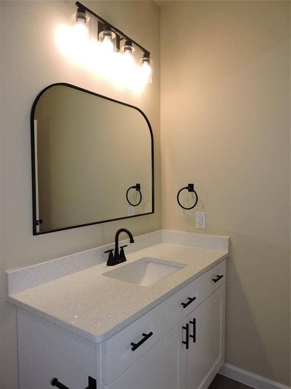 106 Navajo Drive, Mabank, TX 75156 White vanity with flat-panel doors, matte black hardware, white countertop with integrated sink, and a matte black single-handle faucet