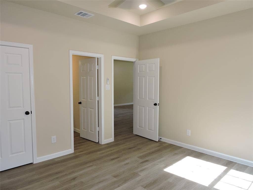 106 Navajo Drive, Mabank, TX 75156 Wood-finish flooring, neutral wall tones, white trim, recessed lighting, and a tray ceiling
