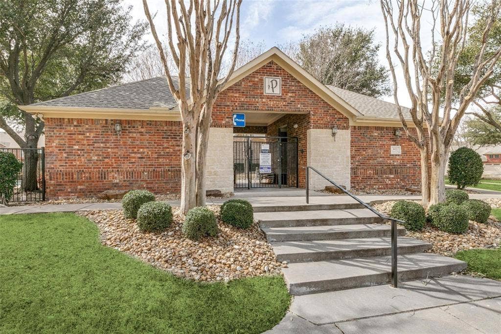 2829 Mott Street, Plano, TX 75025 Brick exterior building with gabled entry, concrete steps, black metal handrails, and a black metal gate