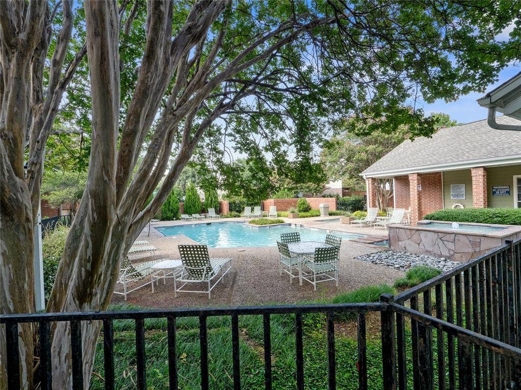 6220 Bentwood Trail, #205, Dallas, TX 75252 Outdoor pool area with surrounding hardscaping, a water feature, and mature trees