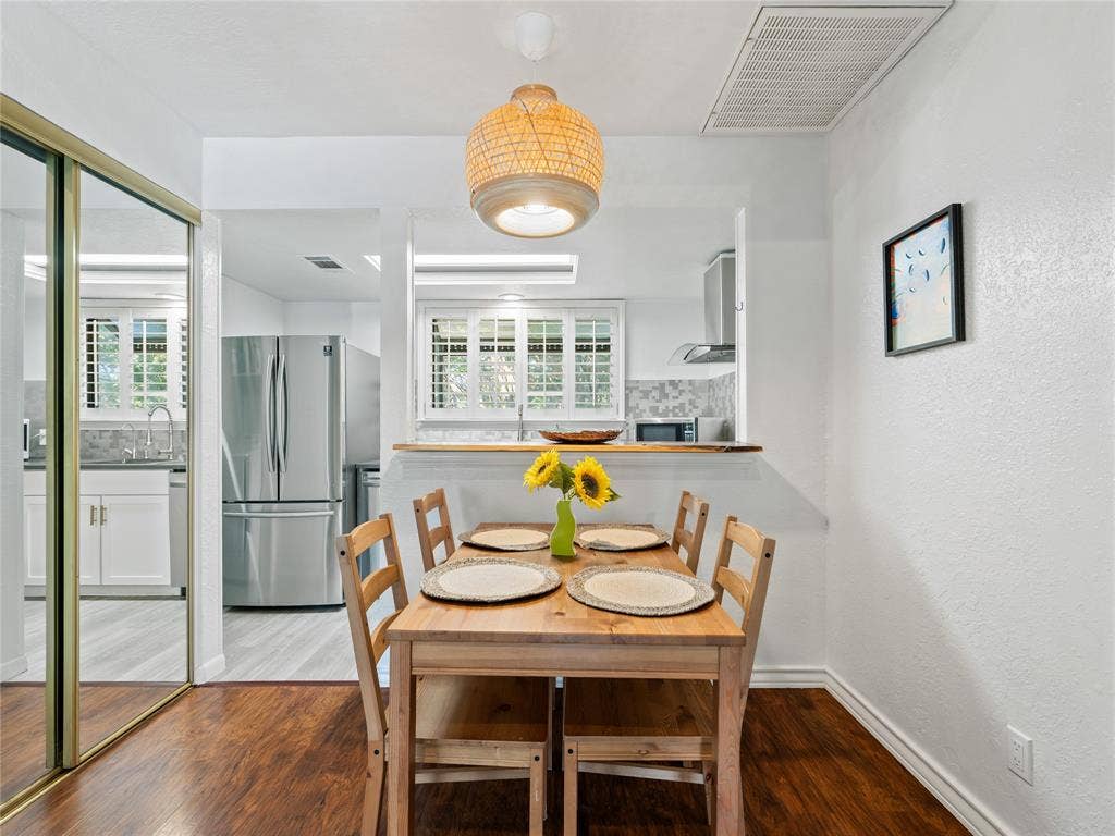 6220 Bentwood Trail, #205, Dallas, TX 75252 Wood-finish flooring, built-in shelving, stainless steel appliances, and white cabinetry