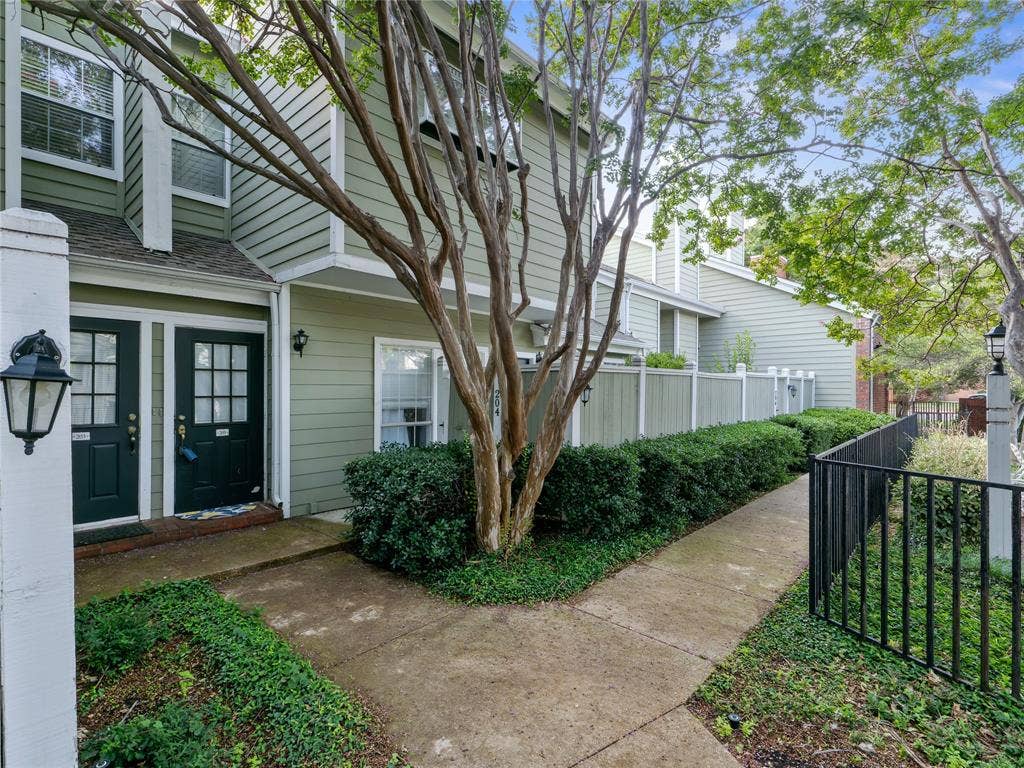 6220 Bentwood Trail, #205, Dallas, TX 75252 Siding exterior with multiple windows and dark paneled entry doors