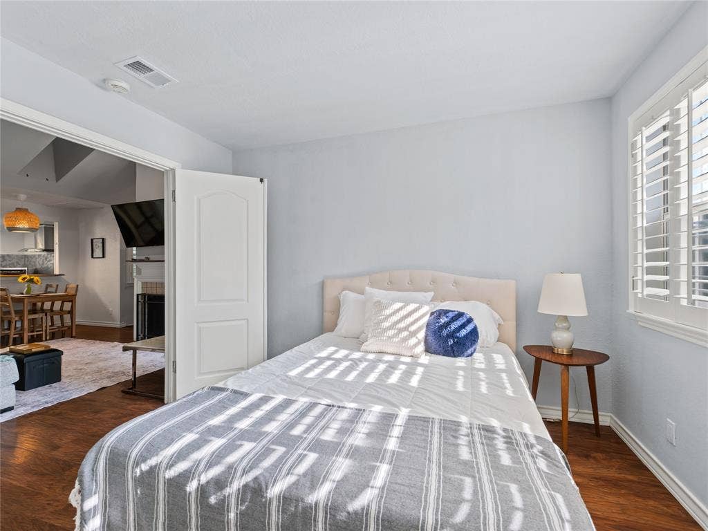6220 Bentwood Trail, #205, Dallas, TX 75252 Wood-finish flooring, plantation shutters, and a paneled interior door