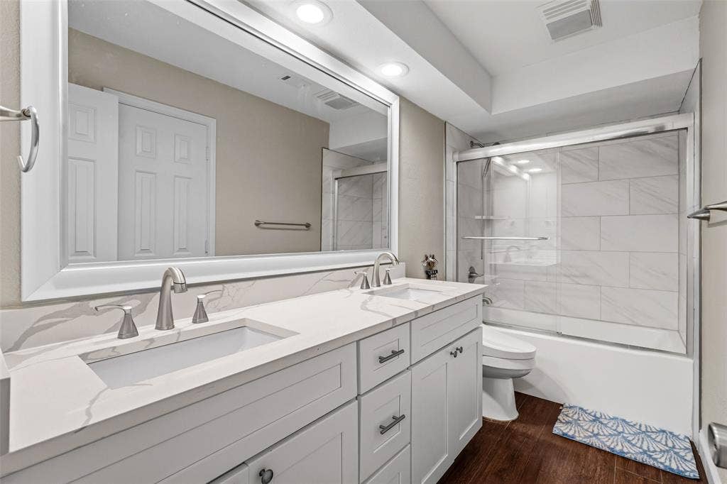 2705 Ithaca Court, Plano, TX 75025 Double vanity with undermount sinks, white cabinetry, and brushed nickel fixtures