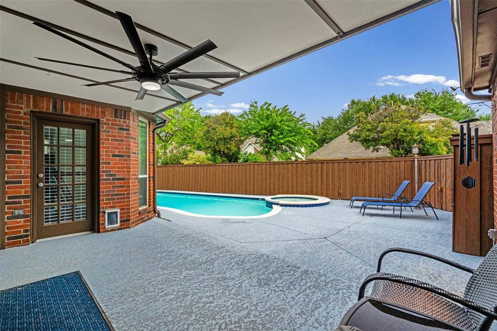 2705 Ithaca Court, Plano, TX 75025 Covered patio with a multi-blade ceiling fan, brick exterior, and a glass-paneled door