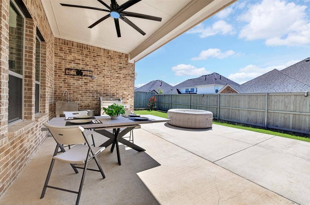 2809 Buckskin Lane, Northlake, TX 76247 Covered patio with a ceiling fan, brick exterior, and a built-in outdoor sink