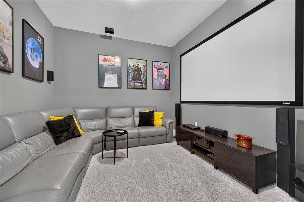 2809 Buckskin Lane, Northlake, TX 76247 Large projection screen with dark frame, wall-mounted speakers, and a built-in media console