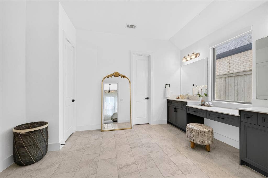 2809 Buckskin Lane, Northlake, TX 76247 Spacious room featuring tile flooring, a large window, a double vanity with ample counter space, built-in cabinetry, and modern light fixtures