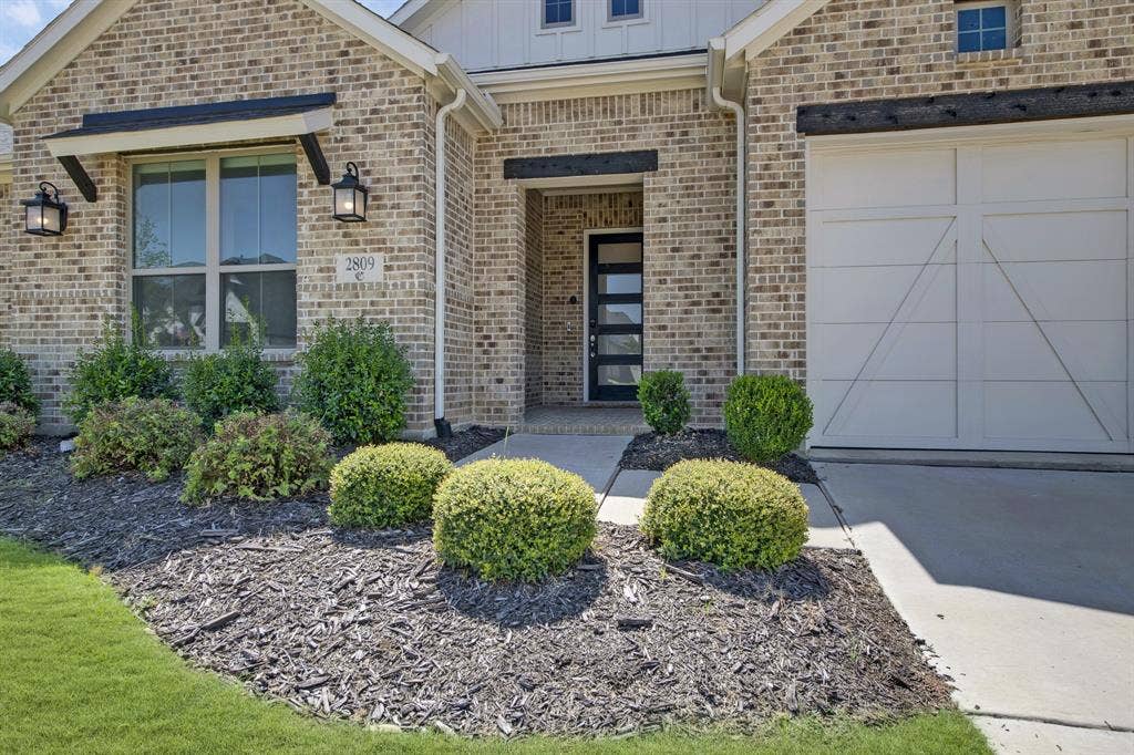 2809 Buckskin Lane, Northlake, TX 76247 Brick exterior with white siding accents and a covered entryway