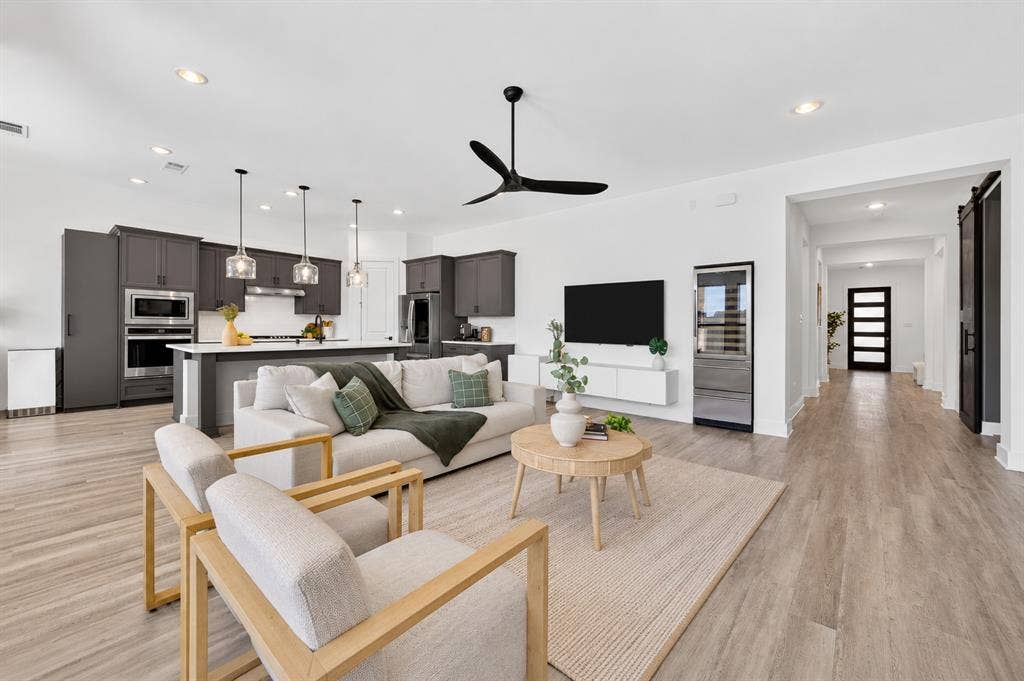 2809 Buckskin Lane, Northlake, TX 76247 Open-concept living area with wood-finish flooring, a contemporary ceiling fan, and recessed lighting