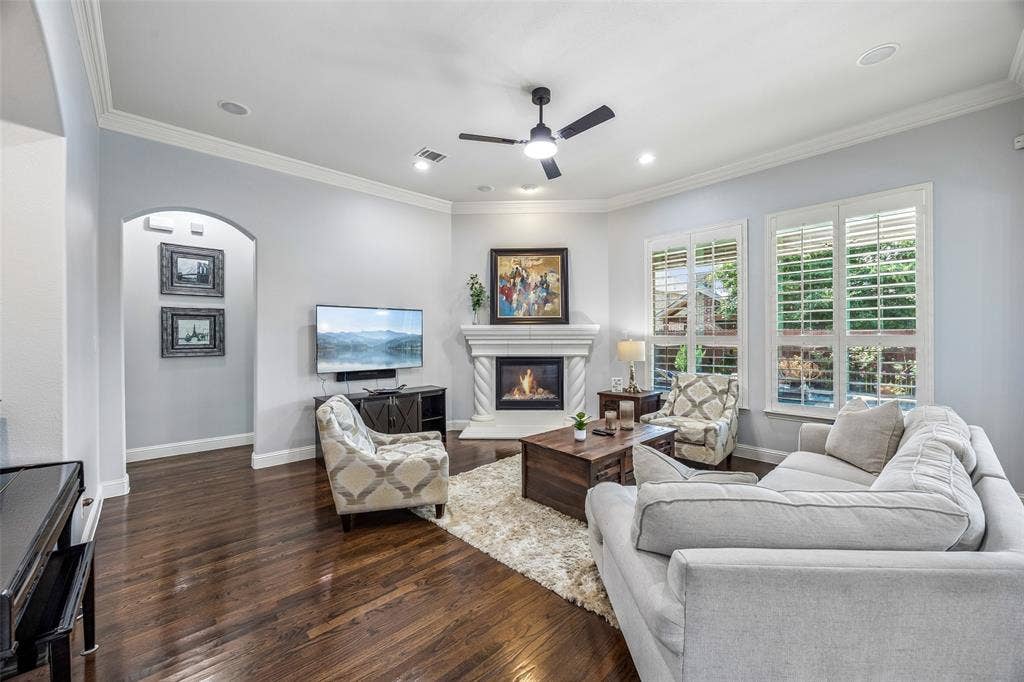 Cozy living room features a stone fireplace and nook for a piano