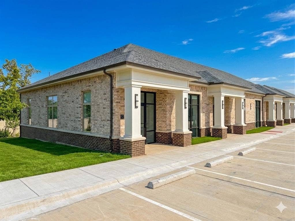 2120 Prairie Drive, #901, Prosper, TX 75078 Modern brick and stone exterior with clean-lined architecture, featuring multiple sets of black-framed glass doors opening onto a concrete patio