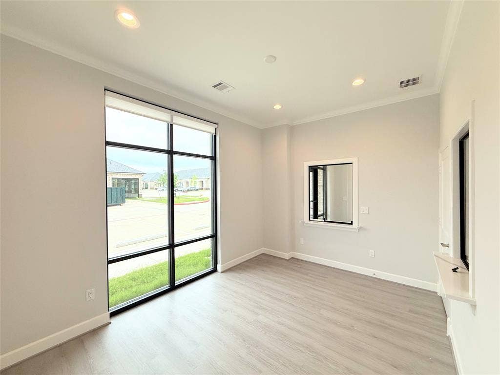 2120 Prairie Drive, #901, Prosper, TX 75078 Expansive window with roller shades, wood-finish flooring, recessed lighting, and crown molding