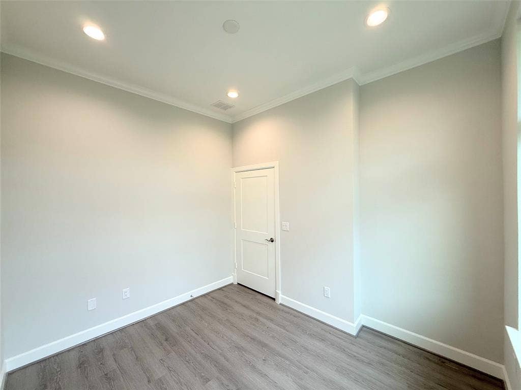 2120 Prairie Drive, #901, Prosper, TX 75078 Recessed lighting, crown molding, wood-finish flooring, white trim, and a paneled door