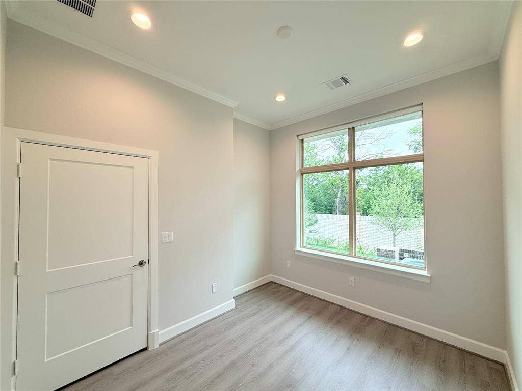 2120 Prairie Drive, #901, Prosper, TX 75078 Recessed lighting, crown molding, a large window, wood-finish flooring, and a flat-panel interior door