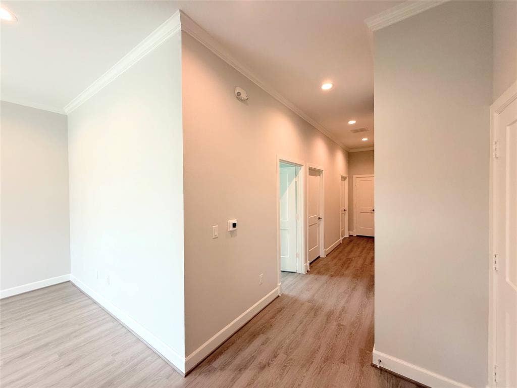 2120 Prairie Drive, #901, Prosper, TX 75078 Recessed lighting illuminates the hallway with wood-finish flooring