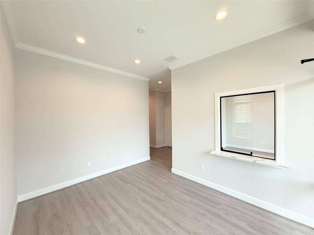 2120 Prairie Drive, #901, Prosper, TX 75078 Recessed lighting, crown molding, wood-finish flooring, interior pass-through window, and neutral wall paint
