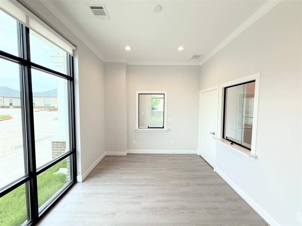 2120 Prairie Drive, #901, Prosper, TX 75078 Expansive floor-to-ceiling window, wood-finish flooring, recessed lighting, crown molding, and high ceilings