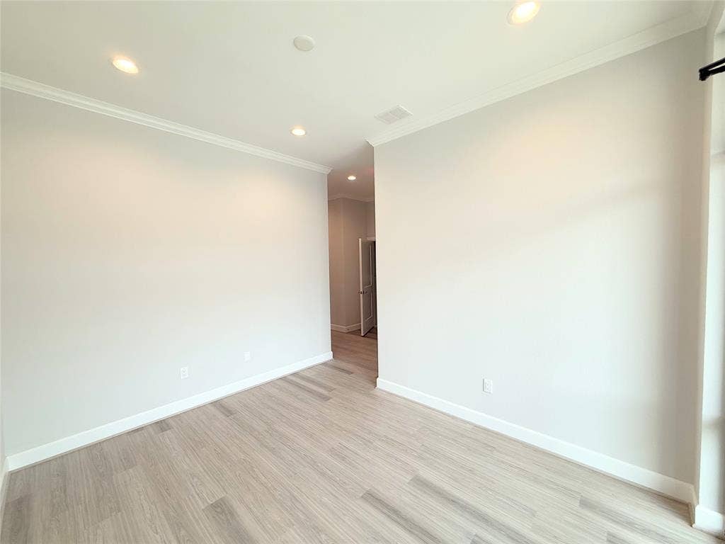 2120 Prairie Drive, #902, Prosper, TX 75078 Wood-finish flooring, recessed lighting, crown molding, and neutral wall tones