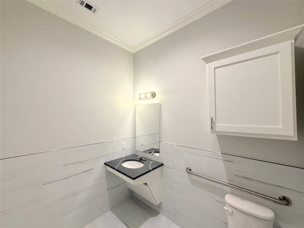 2120 Prairie Drive, #902, Prosper, TX 75078 Floating vanity with an integrated sink and dark countertop