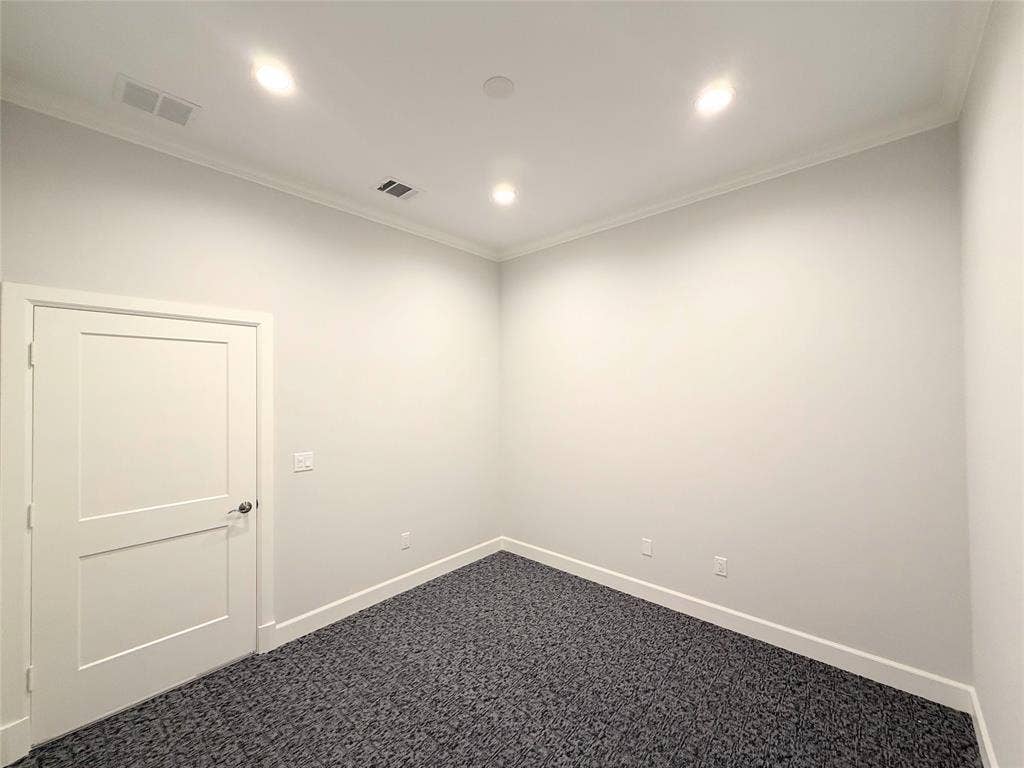 2120 Prairie Drive, #902, Prosper, TX 75078 Recessed lighting, crown molding, two-panel interior door, and dark patterned carpeting