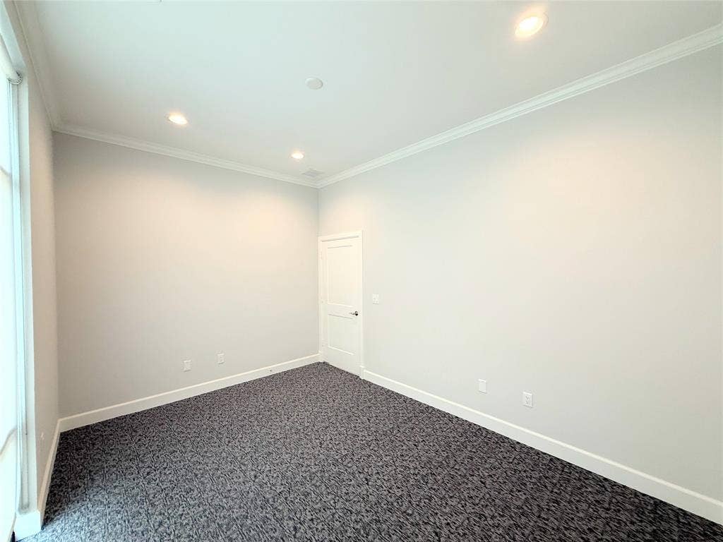 2120 Prairie Drive, #902, Prosper, TX 75078 Recessed lighting illuminates the room, featuring crown molding and a neutral wall color