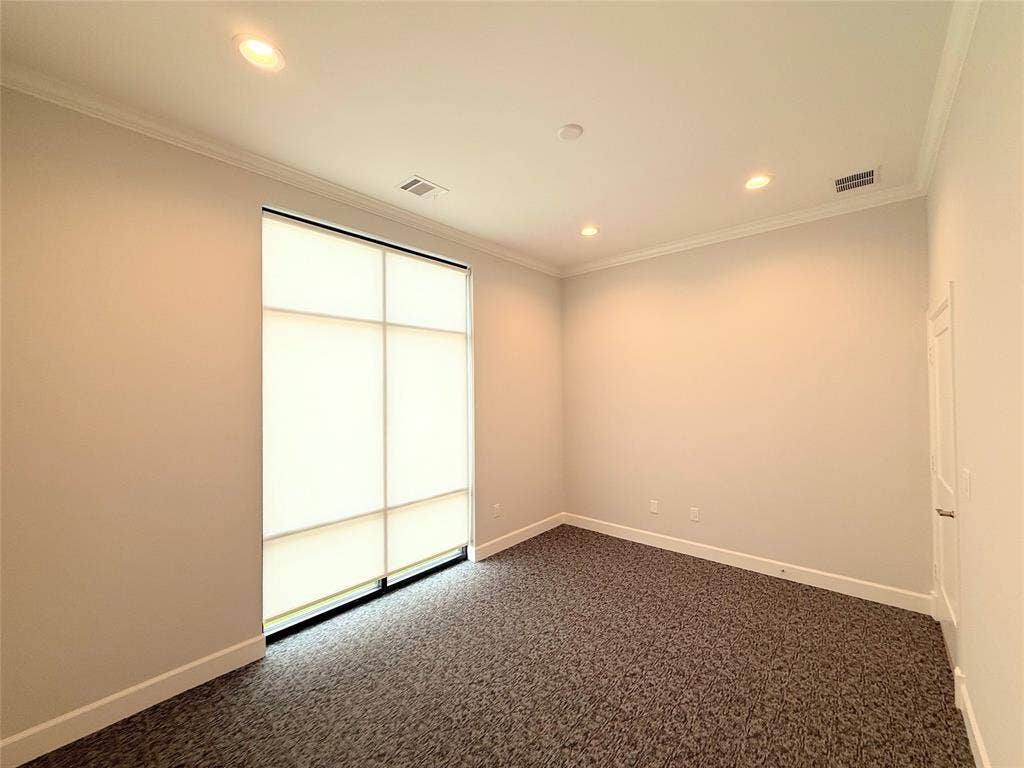 2120 Prairie Drive, #902, Prosper, TX 75078 Recessed ceiling lighting, crown molding, large window with shades, patterned carpeting, and panel door