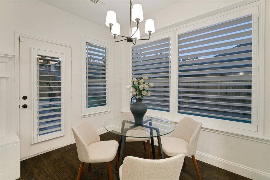 17 Adams Court, Mansfield, TX 76063 Dark wood-finish flooring with white baseboards, decorative alabaster chandlier