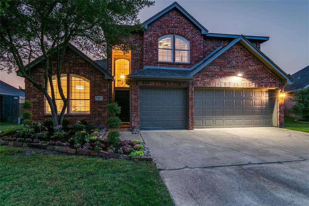 17 Adams Court, Mansfield, TX 76063 Traditional brick exterior with arched windows, a three-car garage, and update fresh landscaping