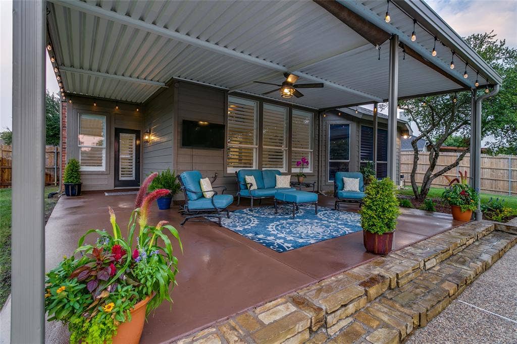 17 Adams Court, Mansfield, TX 76063 Covered patio with integrated ceiling fan, string lighting and stained concrete.