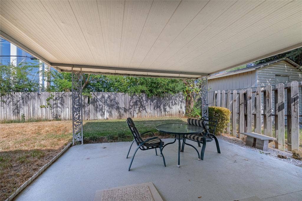 Covered patio featuring a concrete slab and decorative metal supports