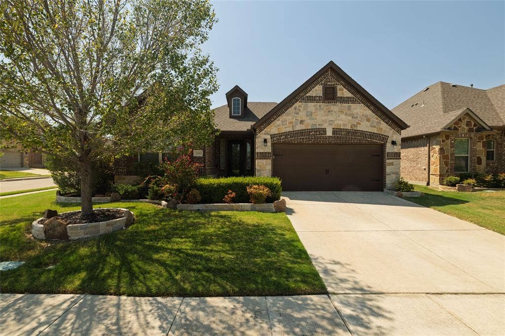 Stone and brick facade with a two-car garage