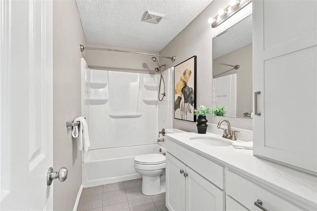 1110 Harvard Lane, Allen, TX 75002 Guest Bath White vanity with integrated sink, brushed nickel faucet, and overhead vanity lighting