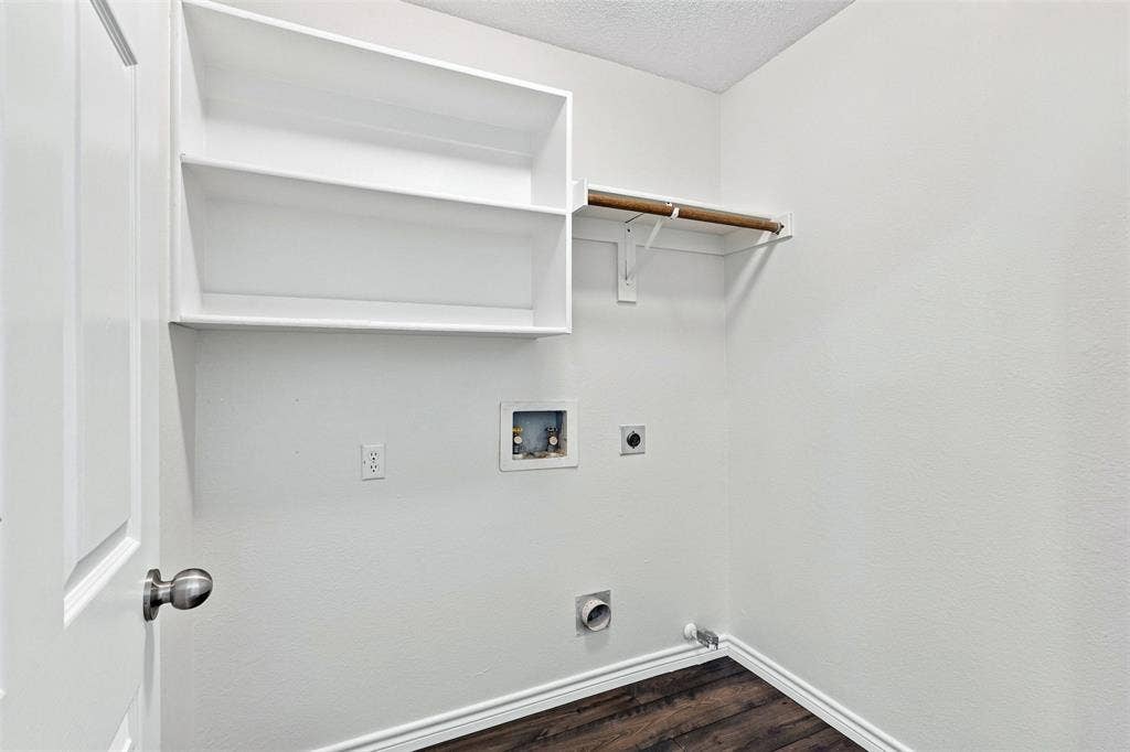1110 Harvard Lane, Allen, TX 75002 Built-in shelving, wood-finish flooring, and a white interior door with a brushed nickel doorknob
