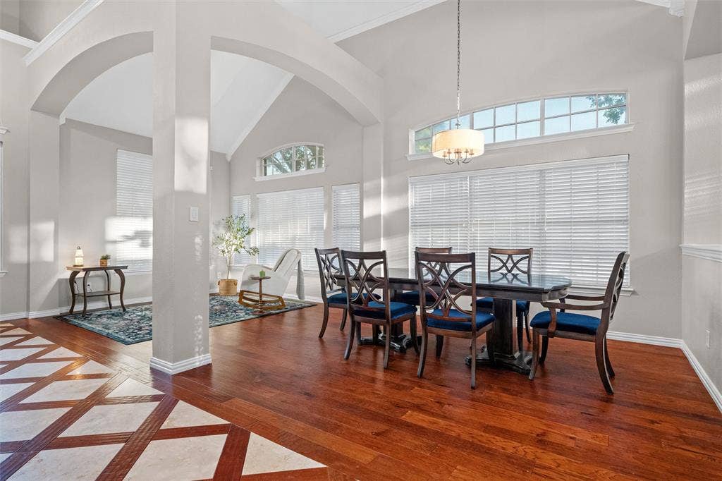 Light filled living and dining spaces with soaring ceilings and seamless flow for entertaining.