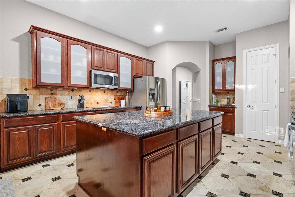 Chef inspired kitchen with expansive island, granite counter tops and ample prep space. Oven and dishwasher replaced 2026.
