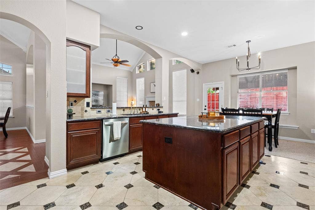 Kitchen overlooks living areas and great view of the backyard oasis through the window.