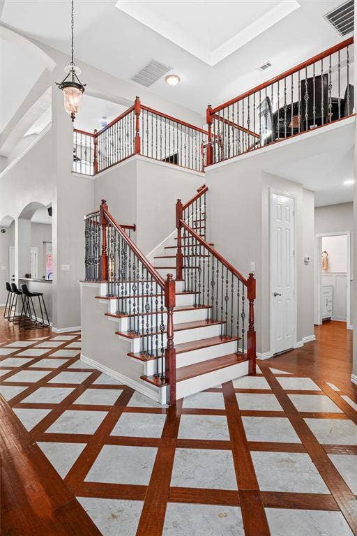 Rich cherry wood floors with custom travertine tile inlays