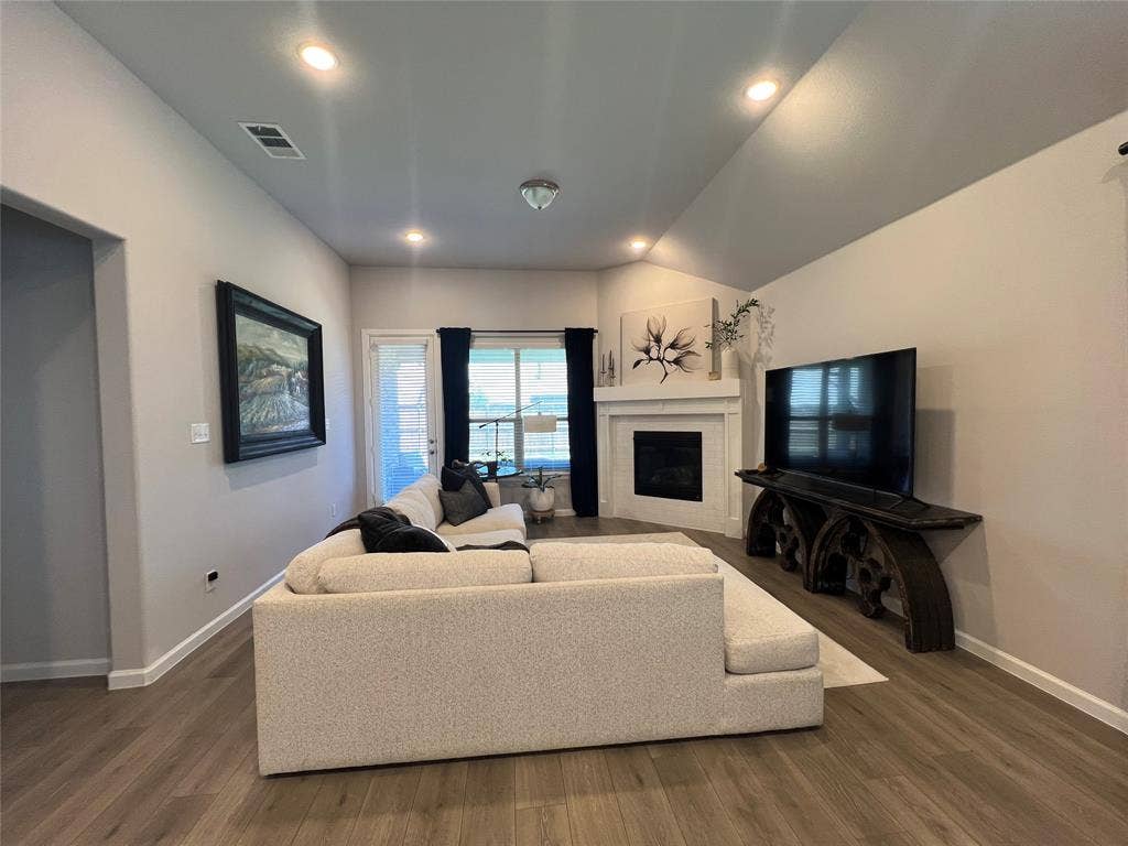 3210 Mattie Grey Lane, Melissa, TX 75454 Living area featuring dark wood-style floors, a fireplace, recessed lighting, and lofted ceiling