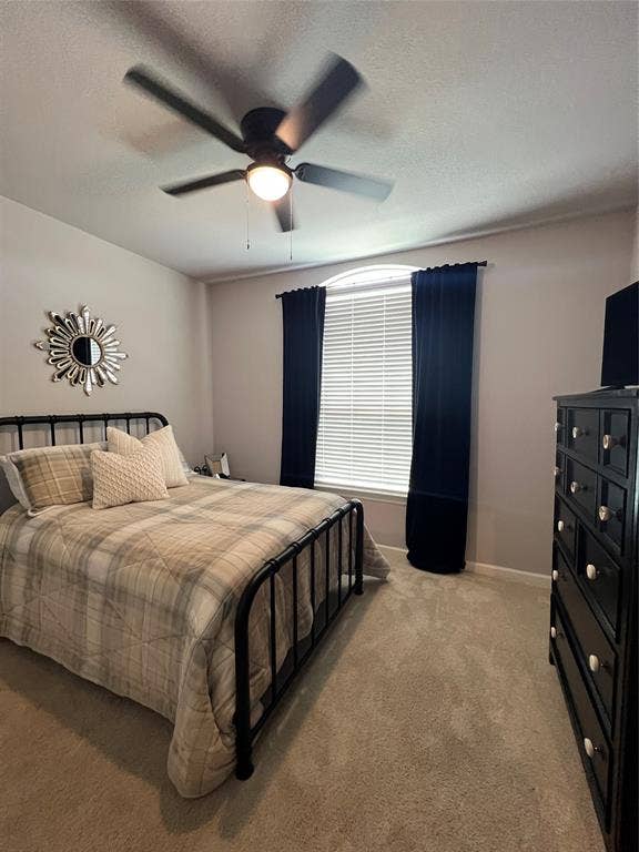 3210 Mattie Grey Lane, Melissa, TX 75454 Bedroom featuring light colored carpet, ceiling fan, and a textured ceiling