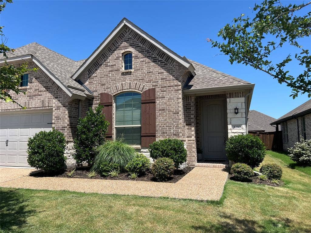 3210 Mattie Grey Lane, Melissa, TX 75454 French country inspired facade featuring brick siding and a shingled roof